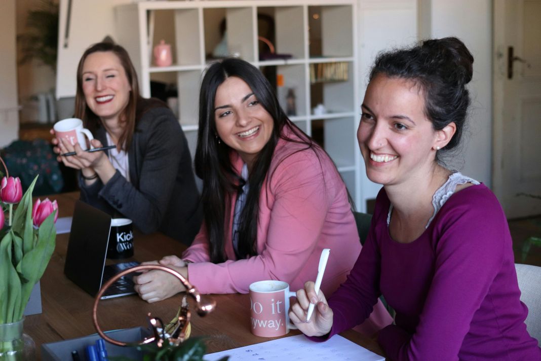 a photo of business women smiling giving feedback about their great seo service