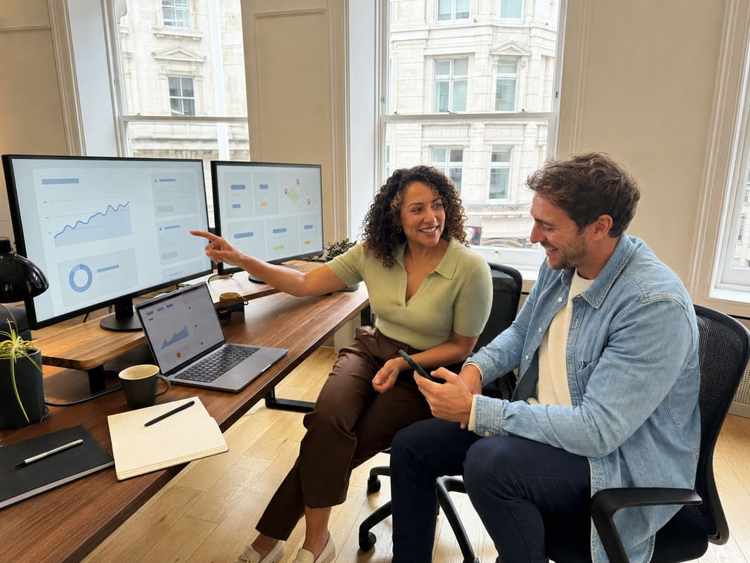 SEO consultant and client reviewing website performance at a desk