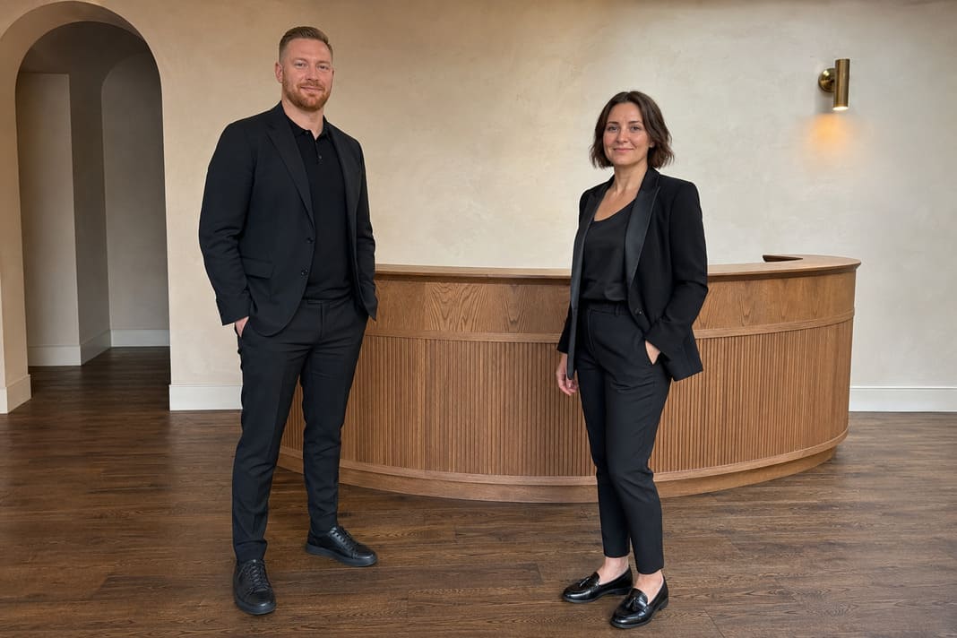 SEO consultants standing in modern Mayfair office reception.